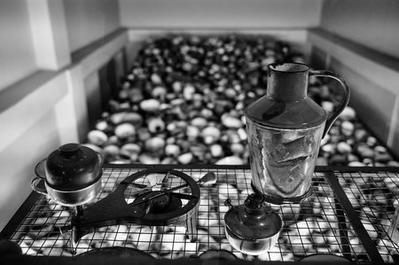 Vintage kitchenware and oil lamps in Auschwitz museum exhibit