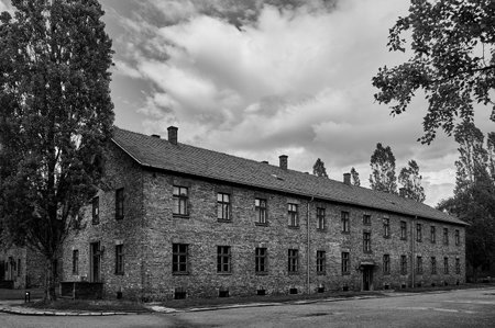 Long brick block barracks under cloudy sky in Auschwitz