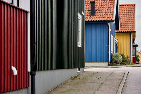 Perspective view of colorful residential facades and rooflines along a street in the naval city of Karlskrona, Blekinge, Sweden, Europeのeditorial素材