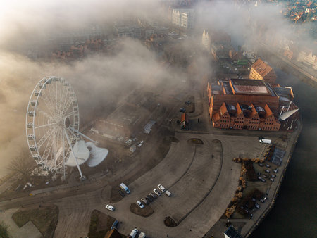 Top down aerial view of the AmberSky Ferris wheel on Olowianka island surrounded by heavy morning...