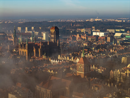 High angle aerial view of St Marys Church and dense historic housing emerging from thick morning...