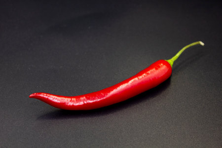 Red hot natural chili pepper. Fresh organic chili pepper on blackの写真素材