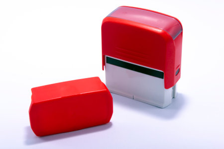 Red, office, automatic, rubber stamp, on white backgroundの写真素材