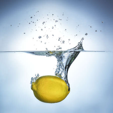 Fresh lemon drops in water