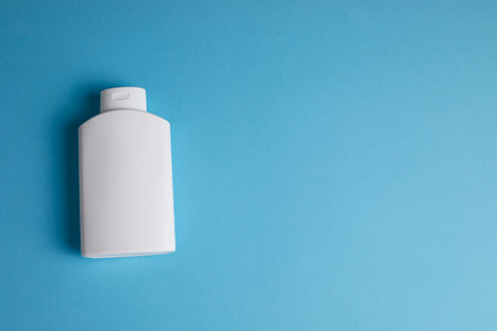 isolated white shower gel packaging on blue background Photographed from aboveの写真素材