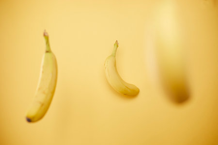 isolated ripe and healthy banana against yellow backgroundの写真素材