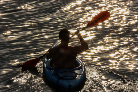 men paddling in a kayakの写真素材