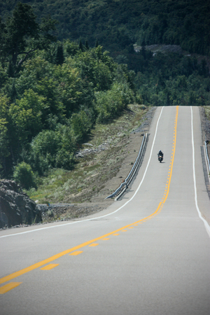guy on a motorcycle on a perfect roadの写真素材