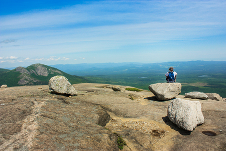 guy sitting on a rock on top of parc des grands-jardinsの写真素材