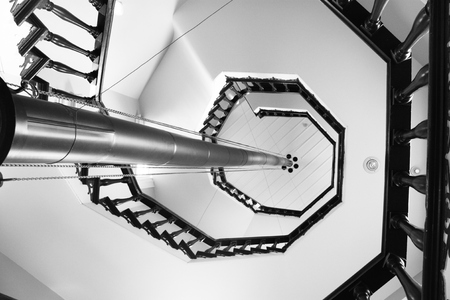 circling stairs going up a white buildingの写真素材