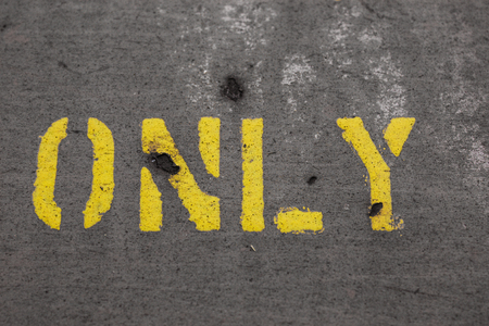 word ONLY painted on a grey wallの写真素材