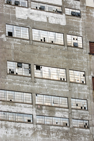 old industrial building with broken windowsの写真素材