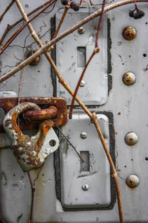 old lock on a rusty metal plateの写真素材