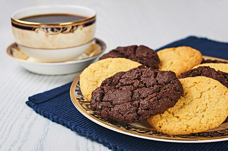 Old-Fashioned Sugar and Double Chocolate Cookies With Coffee on a White Wooden Tableの写真素材