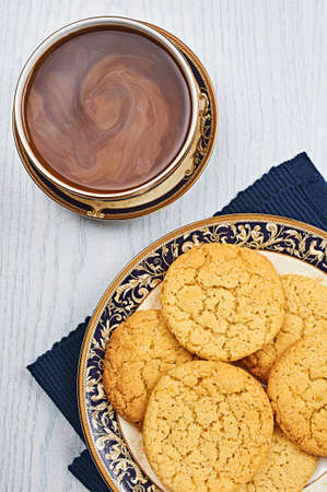 Old-Fashioned Sugar Cookies With Coffee on a White Wooden Tableの写真素材