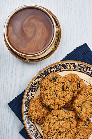 Oatmeal Raisin Cookies With Coffee on a White Wooden Tableの写真素材
