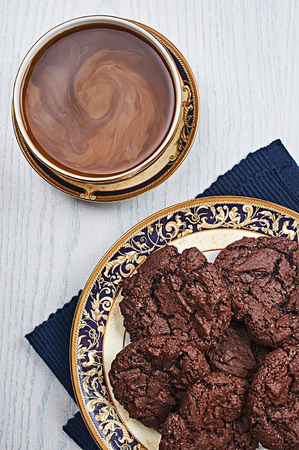 Double Chocolate Cookies With Coffee on a White Wooden Tableの写真素材