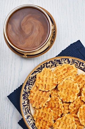 Cheese Caraway Crackers With Coffee on a White Wooden Tableの写真素材