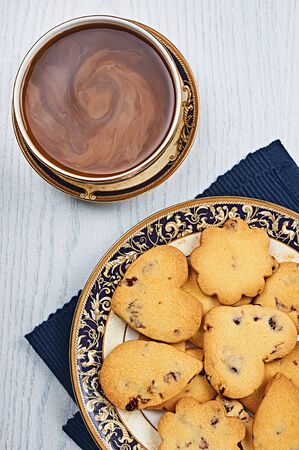 Dried-Cranberry Shortbread Hearts With Coffee on a White Wooden Tableの写真素材