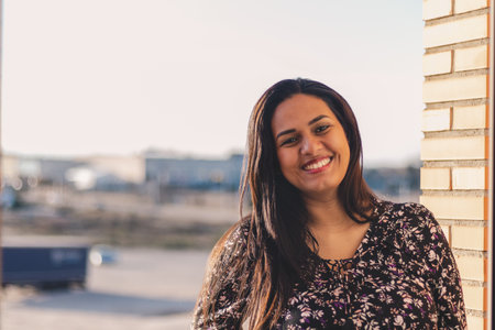 Latin woman smiling on a balcony