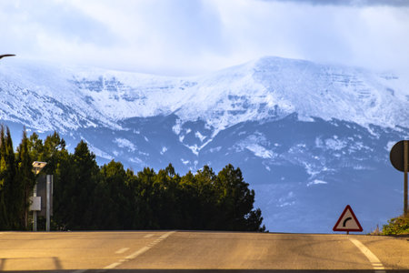 Road with snow-capped mountain in the backgroundの写真素材