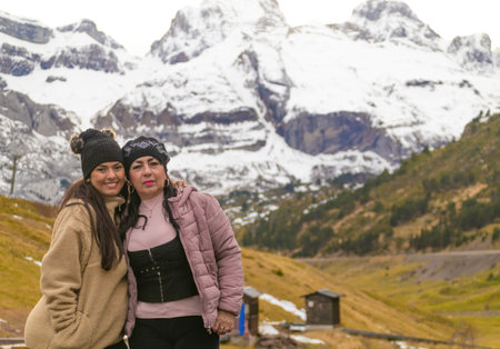Older woman and her grandmother getting to know the Pyrenees and mountains with snow in the background.の写真素材