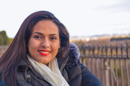 Colombian woman, smiling, looking at the camera, with red lipstick on her face.の写真素材