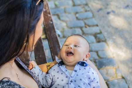 Newborn baby face smiling looking at his motherの写真素材