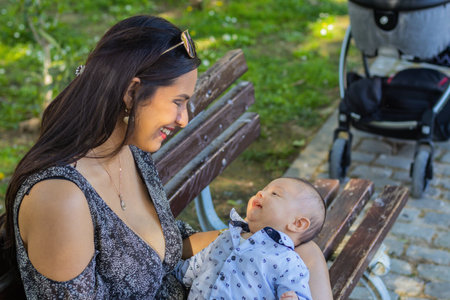 Young woman with her baby playing in a parkの写真素材