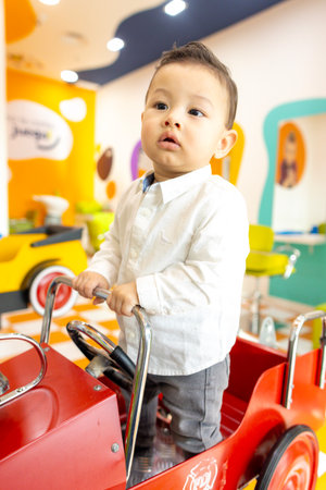Beautiful baby in a childrens hair salon wearing white clothes
