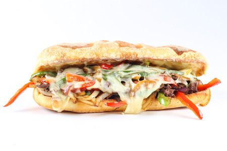 Tasty beef steak sandwich with onions, mushroom and melted provolone cheese in a ciabattaの写真素材