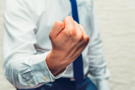 Male, businessman show fist in angry or wanted to say i am winer, i will win, noone can be better than meの写真素材