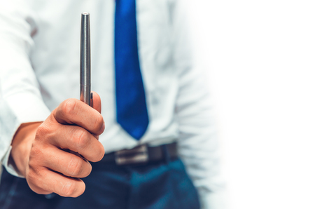 Man holding his pen in front of the camera.の写真素材
