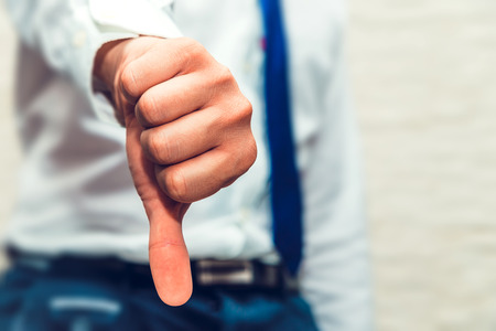 Man show thumb down. Nothing is good, something went wrong.の写真素材