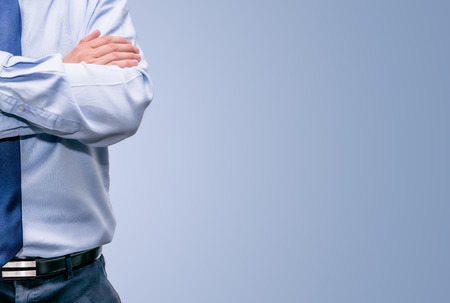 People, Half of Serious business man with crossed hands isolated on white background with space to fill with textの写真素材