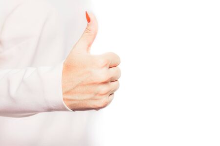 Thumb up. Woman shows thumbs up. Satisfaction, approval, acceptance of deeds. Something like it, like what he sees.の写真素材