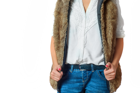 Fashion look on woman. Woman wearing a brown fur jacket and a white shirt.の写真素材