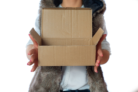 A woman is holding a blank cardboard box in her hand.の写真素材