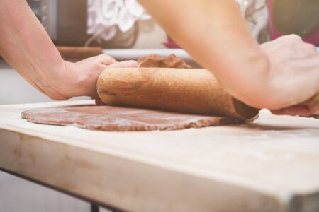 Christmas preparations. Cooking and baking concept. Kneading gingerbread, baking gingerbreads.の写真素材