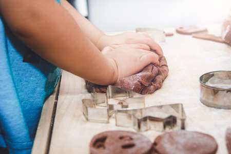 Baking gingerbreads. The family is preparing a gingerbread.の写真素材