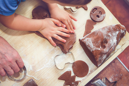 Baking gingerbreads. The family is preparing a gingerbread.の写真素材