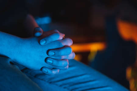 Praying hand of a man in a churchの写真素材