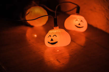 Small glowing pumpkins next to each otherの写真素材
