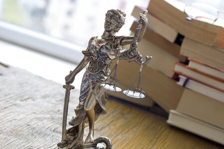 Justice statue with sword and scale and books. Law conceptの写真素材