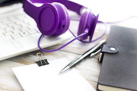 Office workplace with laptop and headphone on wood table