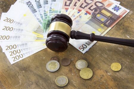 Labor law concept, gavel and money on wooden tableの写真素材