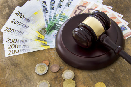 Labor law concept, gavel and money on wooden tableの写真素材