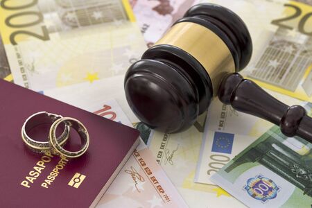 Family law concept, gavel, rings and money on wooden tableの写真素材