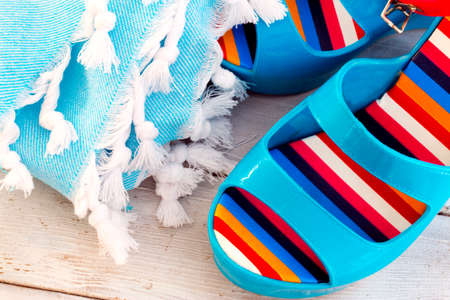 Pair of blue shoes and towel on wood. Vacation in summerの写真素材