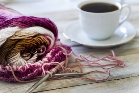 Skeins of wool and knitting needles on wooden backgroundの写真素材
